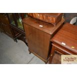 A mahogany music cabinet fitted with sliding trays