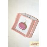 A dress ring set with a pink stone