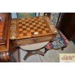 A Victorian rosewood and inlaid games/sewing table
