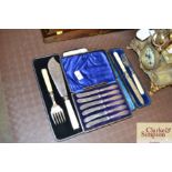 A cased set of silver handled butter knives; and o