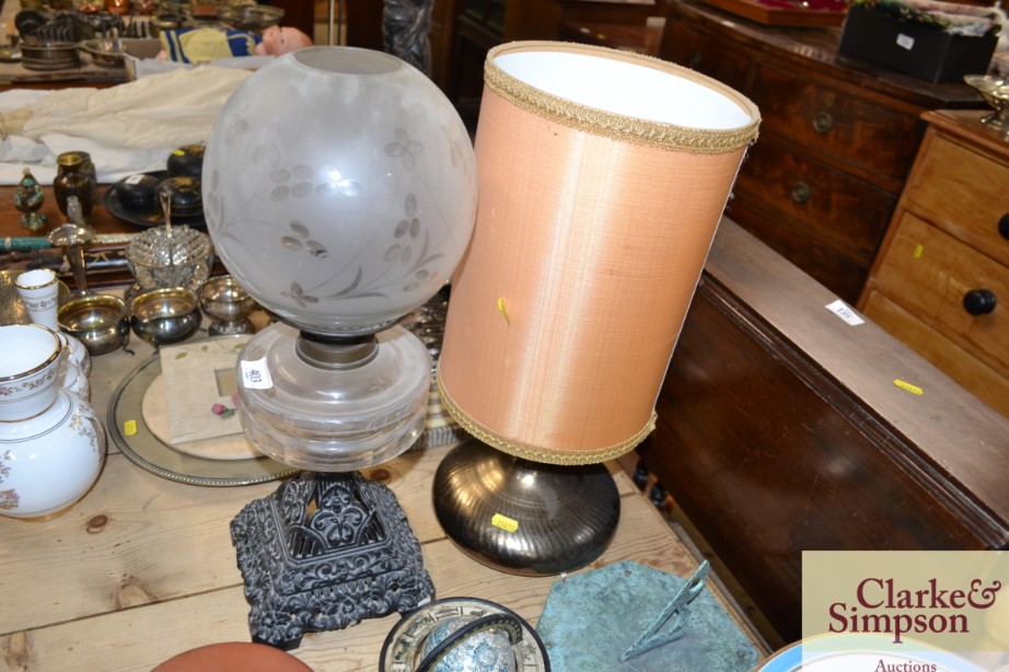 A Victorian glass oil lamp on cast iron base; and