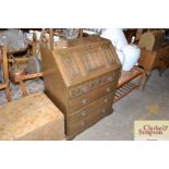 An oak bureau with linen fold decorated fall