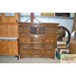 A reproduction oak court cupboard