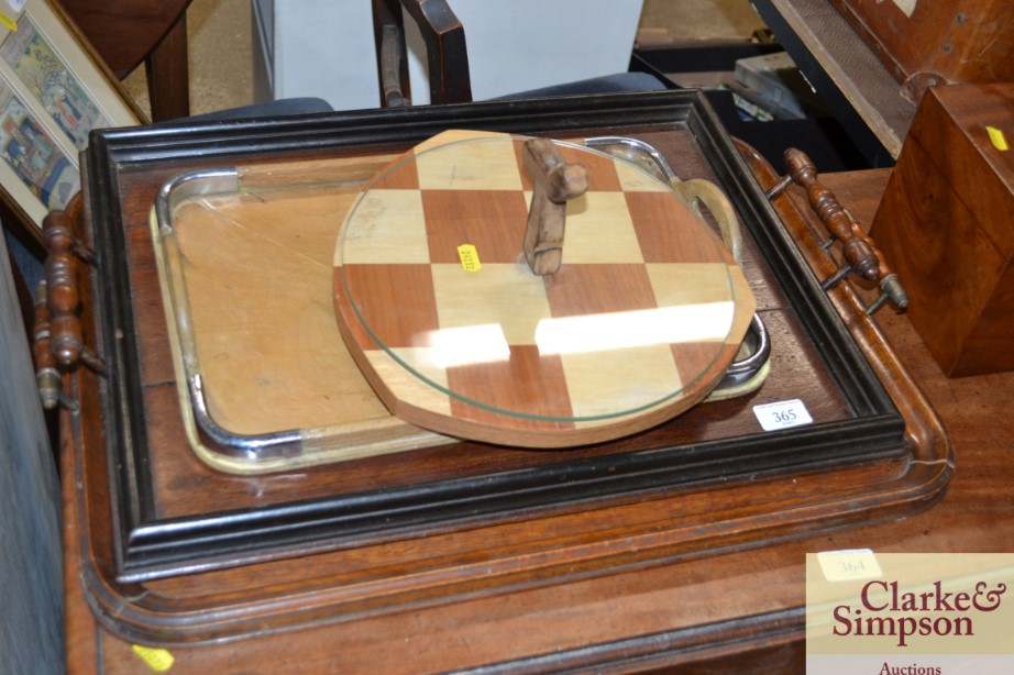 Three various wooden tea trays and a cheese board