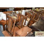Five oak barley twist and cane back dining chairs together with an oak drawer leaf table