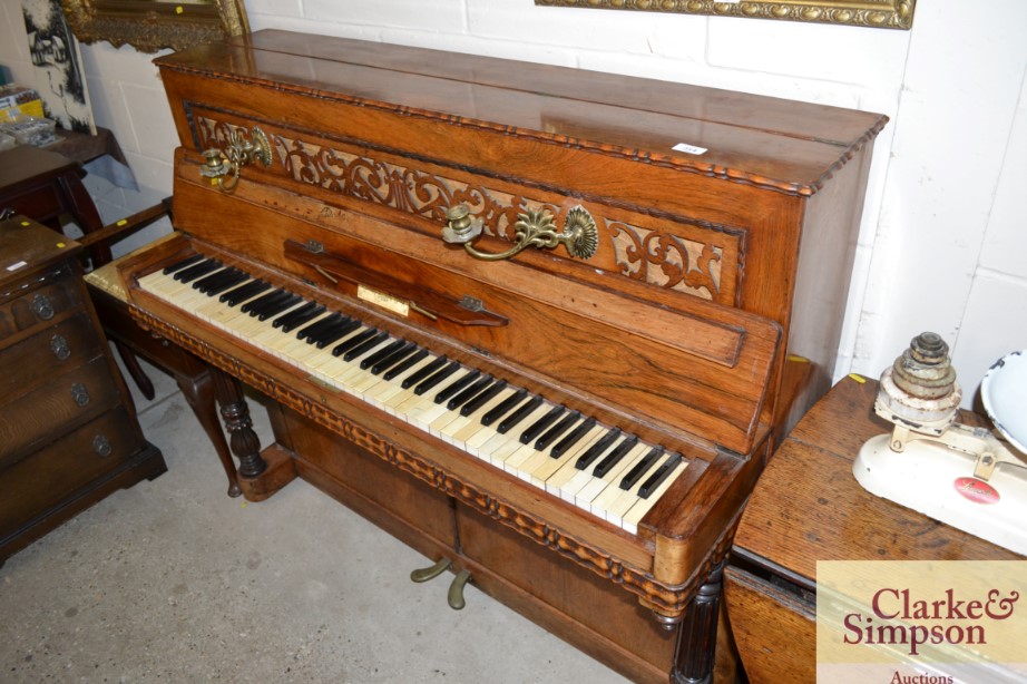 A Victorian walnut cased piano with brass candle s