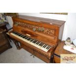 A Victorian walnut cased piano with brass candle s