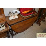 An antique oak gate leg dining table