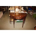 A mahogany 19th Century tea table raised on square taper