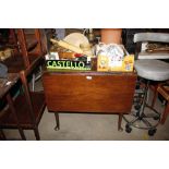 An antique drop leaf table missing one leaf, raised