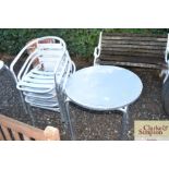 A stainless steel table and a set of four chairs