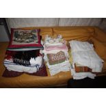 Four bundles of cushions, linens etc