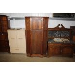 An oak linen fold decorated wardrobe