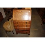 An oak bureau fitted four graduating drawers