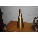 A reproduction brass megaphone