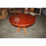 A reproduction mahogany circular topped table