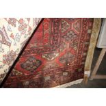 An approx. 10'4" x 6'4" red Eastern pattern rug