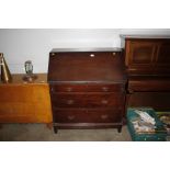 A mahogany bureau fitted with three drawers