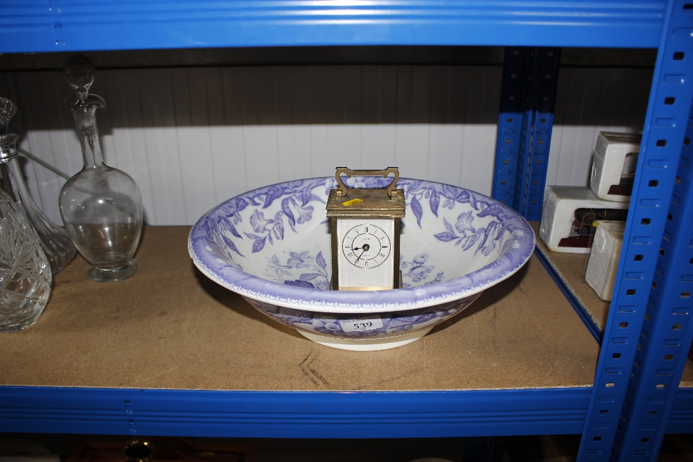 A wash bowl and mantel clock