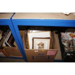 A box containing various pictures and prints and b