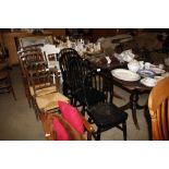 A set of four black painted stick back dining chair