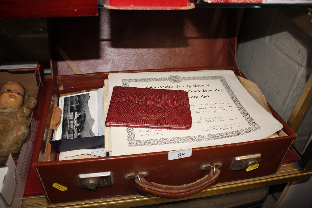 A small suitcase and contents of various ephemera