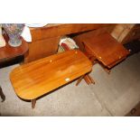 A nest of three teak coffee tables; and a oval ret