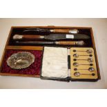 A cased three piece horn handled carving set with