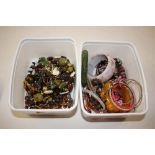 Two tubs of miscellaneous costume jewellery, bangl