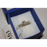An 18ct gold ring set with a tear drop diamond fla