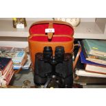A pair of binoculars in fitted leather case