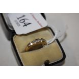 An 18ct gold ring (marks rubbed), size K, set with