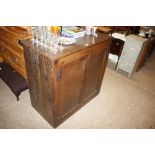 An antique oak storage cupboard