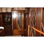 An Edwardian inlaid mahogany mirror door wardrobe