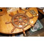 A small wooden and brass mounted ships wheel