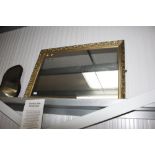 A gilt framed wall mirror