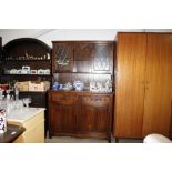 An oak and leaded glazed dresser with linen fold d