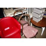 A red leather tub chair and matching pouffe