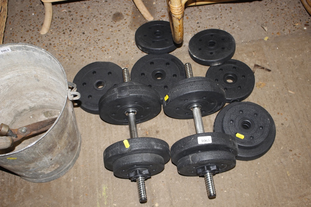 A pair of dumbbells and extra weights