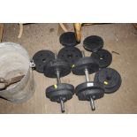 A pair of dumbbells and extra weights