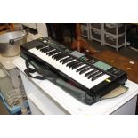 A Yamaha PSR-12 keyboard with carry case