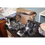 A quantity of various cameras, lenses, bag
