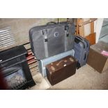 Three suitcases and a wooden box