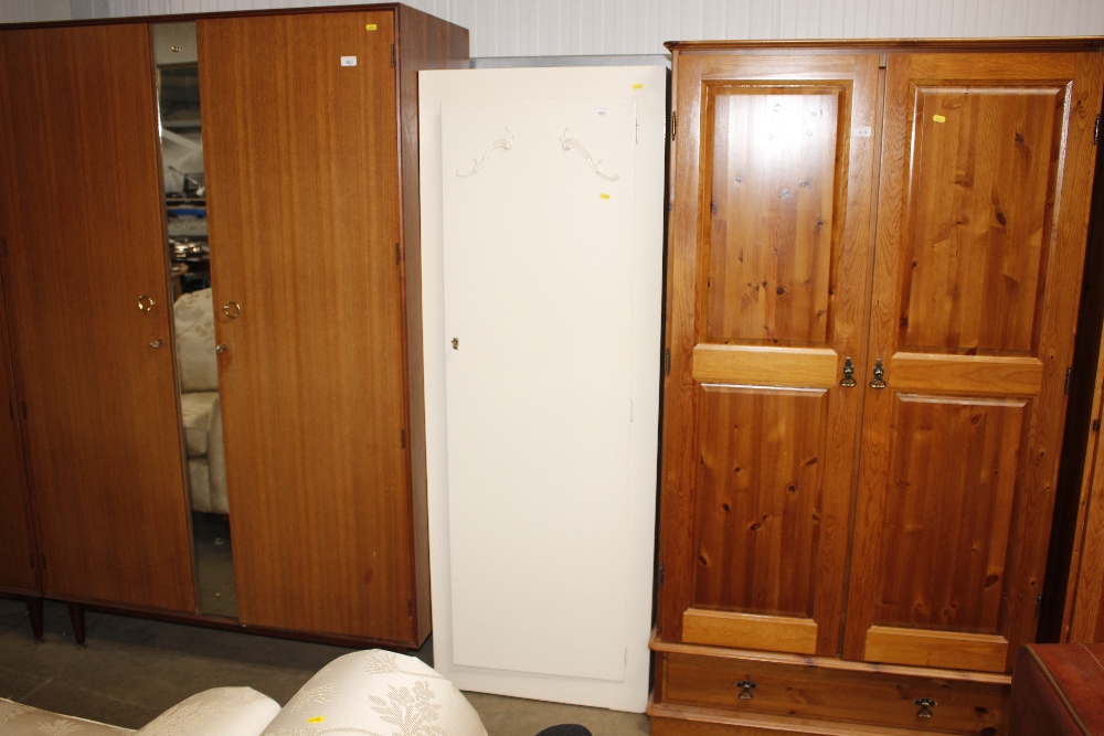 A white painted single door wardrobe