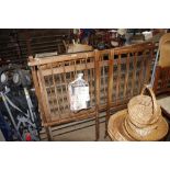 A vintage cot together with a box of feeding bottl