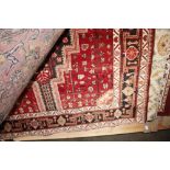 An approx 10'3" x 5'2" red floral patterned rug