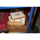 A box containing various pictures and prints