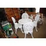 A Victorian style metal garden table and four matc