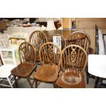 A set of six stick and wheel back chairs to includ