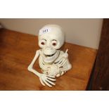 A novelty moneybox in the form of a skeleton